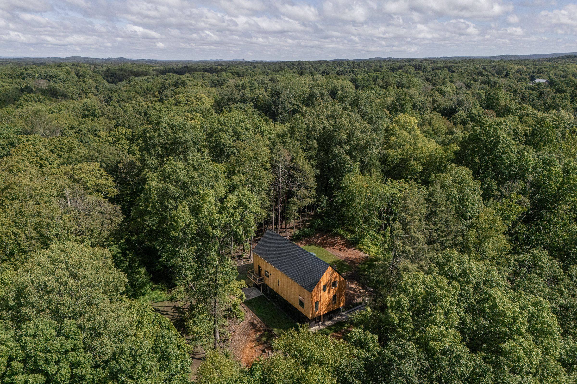 Aerial view of the house in three wooded acres, Rhinebeck